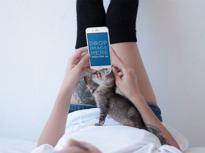 iPhone Mockup in Portrait Position of a Tattooed Woman with a Kitten 