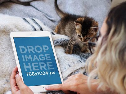 Young Woman Lying in Bed with her Kitten and Using a White iPad Mini Mockup 12791standard