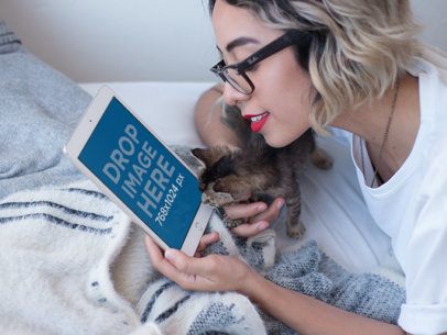 iPad Mockup in Portrait Position Featuring a Woman with a Kitten