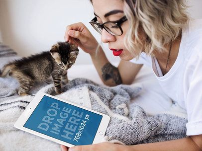 Hipster Girl Lying in her Bed with a Kitten and White iPad Mini Mockup a12793