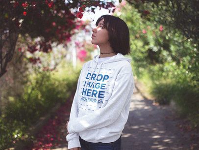 Young Asian Woman with Short Hair Standing in a Garden Pullover Hoodie Mockup a12652