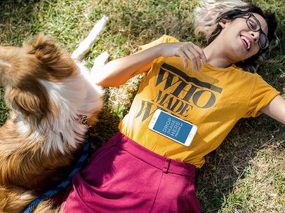 iPhone Mockup of a Young Woman Lying in the Grass with her Dog