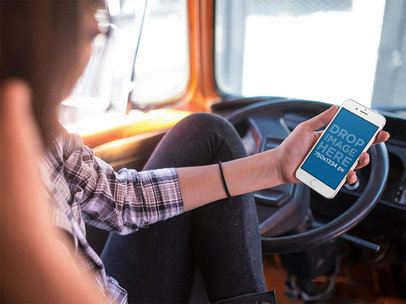 Mockup of a Woman Checking Her iPhone 6s in the Driver's Seat of a Car