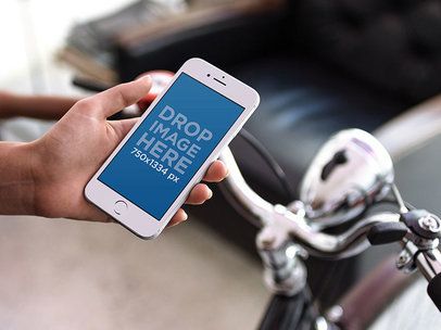 White iPhone 6s Mockup Held by a Man About to Go on a Bicycle Ride 12964