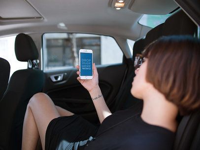 iPhone Mockup in Portrait Position of a Woman Resting in a Car 