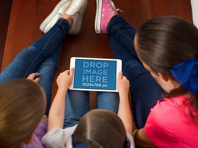 iPad Mini in Landscape Position Mockup of Three Friends Using an iPad at Home