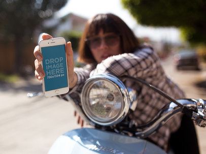 iPhone Mockup in Portrait Position Featuring a Woman in a Vintage Scooter Outdoors