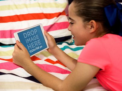 Little Girl Playing with her iPad Mini in her Bedroom Mockup