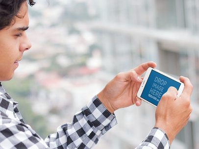 iPhone Mockup in Landscape Position Featuring a Young Man