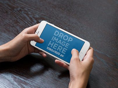iPhone Mockup in Landscape Position Lying over a Wooden Surface