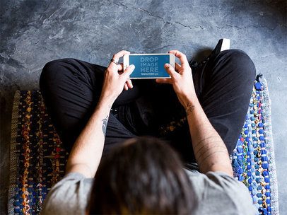 Man Playing With iPhone Mockup Overhead Shot a13109s
