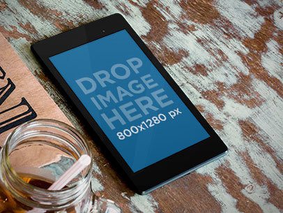 Mockup Featuring a Nexus 7 in Portrait Position Placed on a Rustic Textured Table