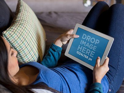 Mockup of a Woman Chilling on a Couch Staring at an iPad in Landscape Position 13098s