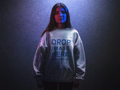Crewneck Mockup Featuring a Woman with Long Hair Standing in Blue and Red Lights