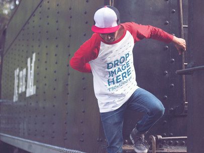 Guy Wearing a Cap and Raglan 3/4 Sleeve T-Shirt Mockup Jumping from a Train a12492