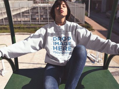 Crewneck Mockup of a Beautiful Girl with Short Hair Sitting with Her Eyes Closed in the Sun a12656