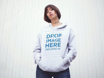 Trendy Asian Woman Wearing a Pullover Hoodie with her Hands in her Pocket