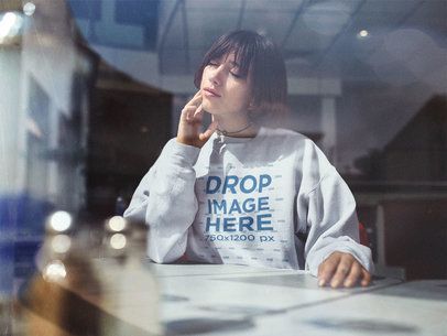 Trendy Young Woman Wearing a Crewneck Mockup and Choker at a Café a12668