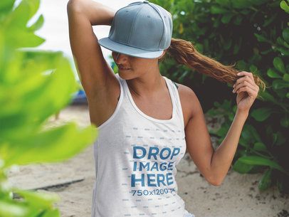Beautiful Woman with a Pony Tail Wearing a Tank Top and Hat at the Beach