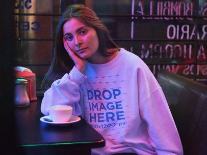 Crewneck Mockup Featuring a Lovely Woman Waiting in a Late Night Caf��