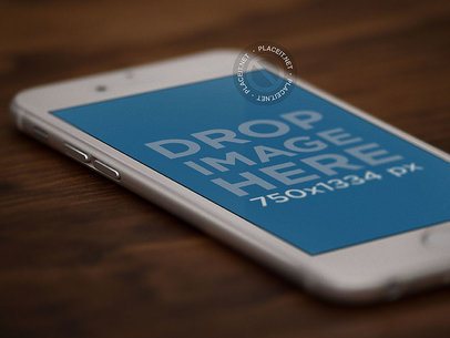 Close Up Mockup of an Angled White iPhone Over a Wooden Texture a12704