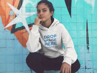 Pretty Woman Crouching in a Abandoned Pool Wearing a Pullover Hoodie Mockup