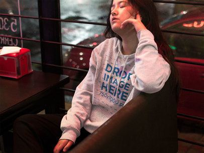 Asian Girl Closing her Eyes at a Late Night Diner Pullover Hoodie Mockup a12697