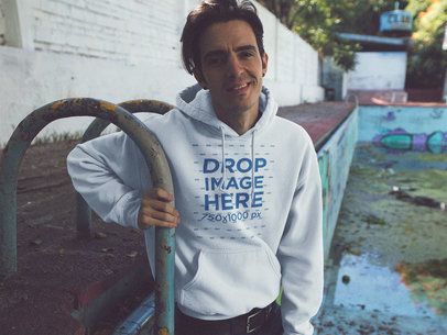 Skater Guy Wearing a Pullover Hoodie Mockup at a Pool