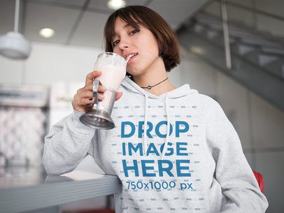 Pullover Hoodie Mockup Featuring a Woman with Short Hair Drinking a Milkshake