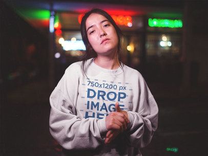 Mockup of an Asian Woman Wearing a Crewneck Sweatshirt Outside a Road Diner a12712