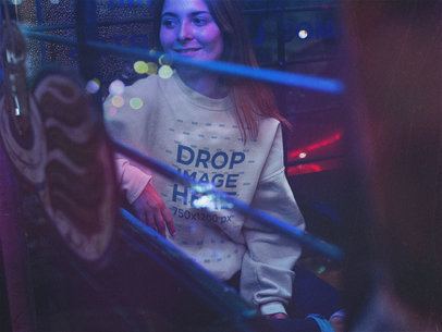 Crewneck Sweatshirt Mockup Featuring a Beautiful Woman Sitting in Neon Lights