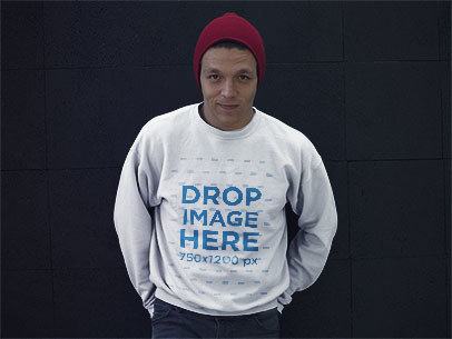 Crewneck Mockup of a Guy Standing in Front of a Black Wall with a Beanie