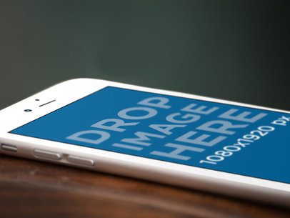 White Angled iPhone Close Up Mockup Over a Wooden Surface
