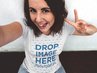 Trendy Woman Wearing a Round Neck T-Shirt Taking a Selfie with a Funny Face