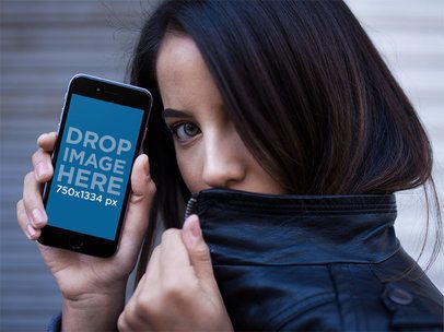 Mockup Of A Woman With Green Eyes Hiding While Showing A Black iPhone 7