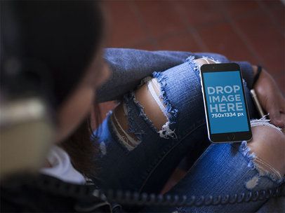 Over Shoulder Mockup Of A Girl Listening To Music While Her iPhone Is On Her Legs a14044s