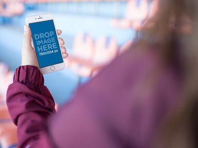 Mockup Of A Woman Using Her White iPhone While At A Red And Blue Stadium