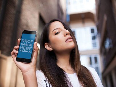 Mockup of a Young Woman with Long Hair Showing the Screen of an iPhone 6