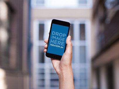 Mockup of a Woman Holding High an iPhone 6
