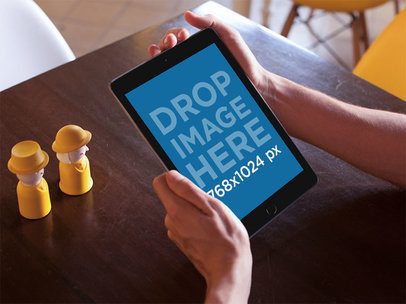 Mockup of an iPad Being Held in Portrait Position by a Man