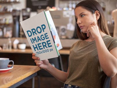 Mockup of a Beautiful Woman Reading a Magazine While at a Cafe