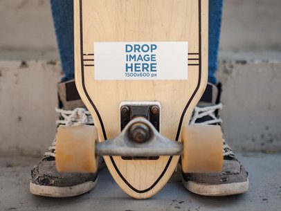 Horizontal Sticker on a Longboard Held by a Man Mockup a14337
