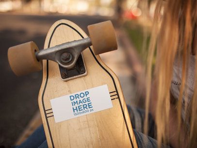 Long Haired Girl Holding a Longboard With a Sticker Glued to it While Outdoors Mockup a14309