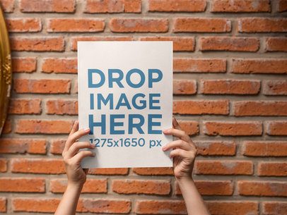 Magazine Held by Two Hands While Against a Bricks Wall Template a14367