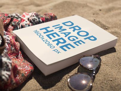 Book Lying on the Beach Near Sunglasses and a Skirt Mockup a14276