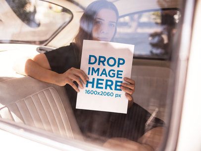 Mockup of a Girl Holding a Big Book While Inside a Car a14399