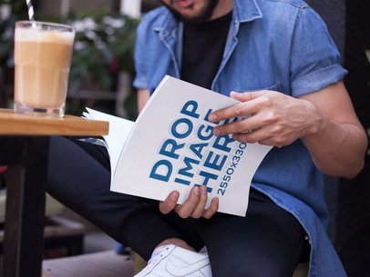 Young Guy Reading a Magazine While Drinking a Smoothie in a Cafe Outdoors Mockupa14456 