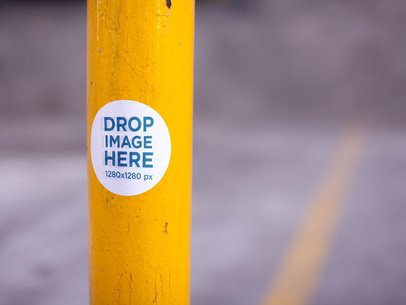 Round Sticker on a Yellow Pole in a Parking Lot Mockup