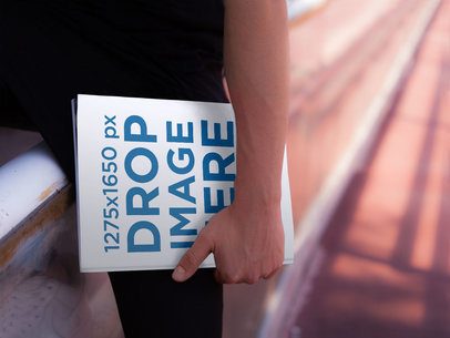 Template of a Young Man Holding a Magazine While in a Running Track