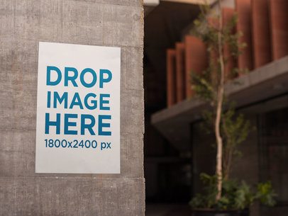 Poster on a Concrete Wall Near a Young Tree in the City Mockup